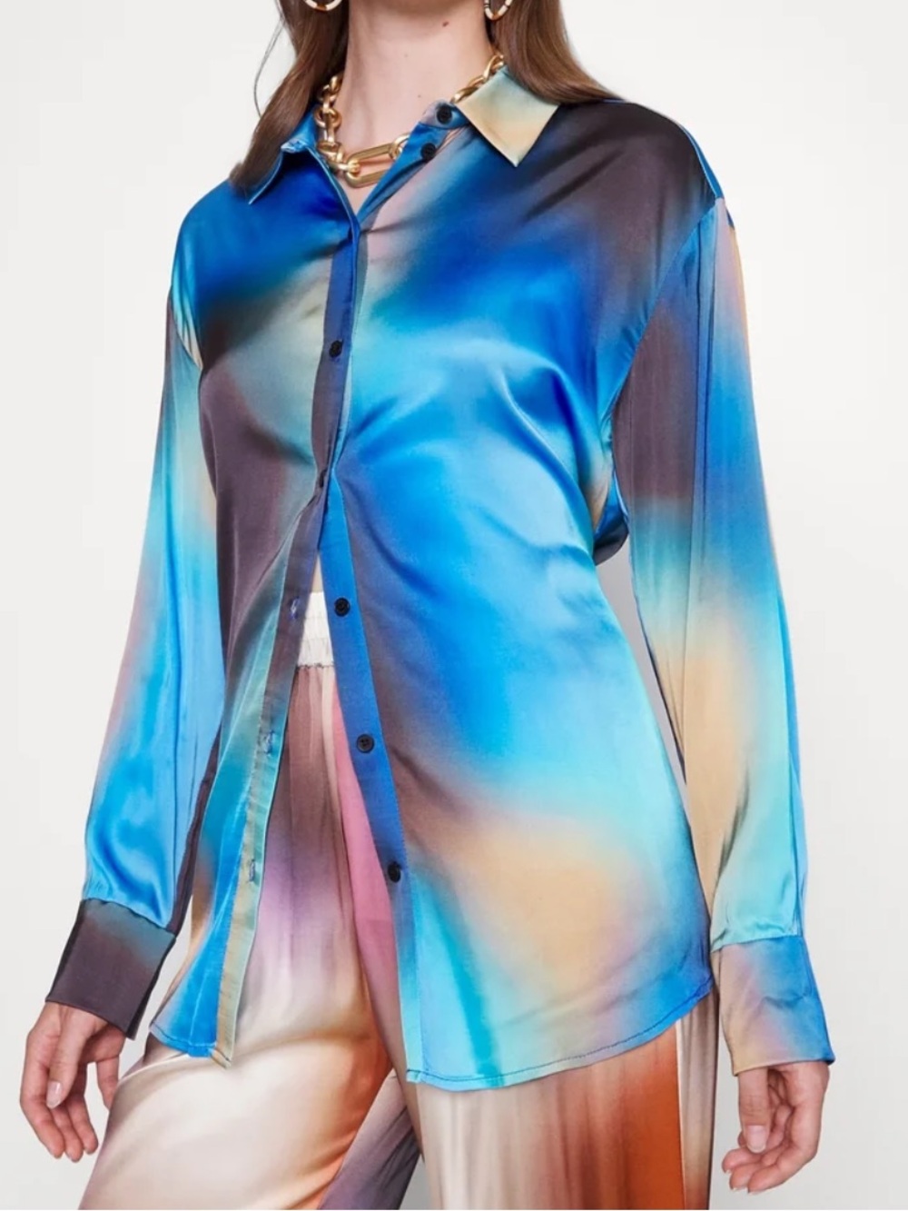 Munthe blouse features a blue, orange, and brown gradient pattern